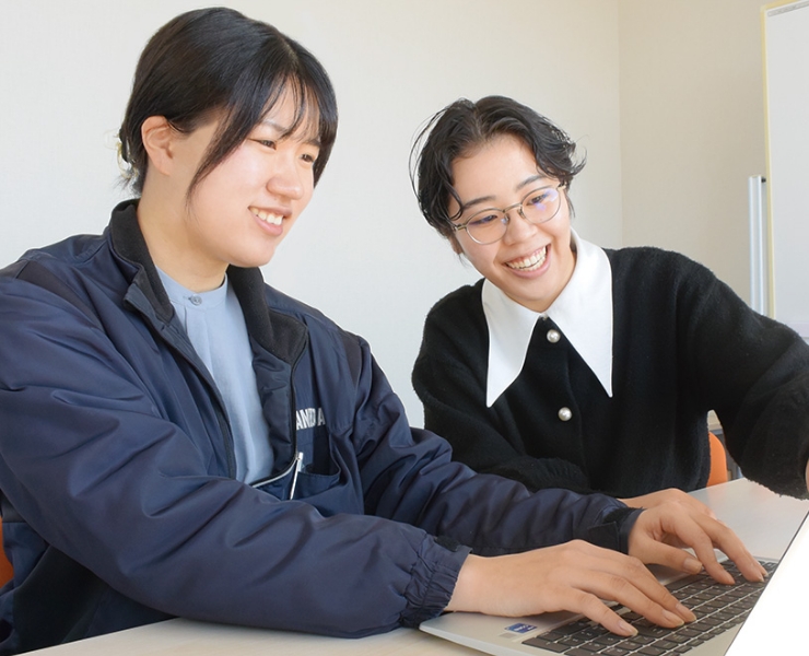 社員同士が助け合いながら仕事をしている写真